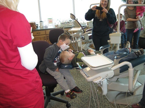 Young kids playing in a dental chair