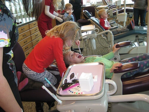 young kids playing in a dental chair