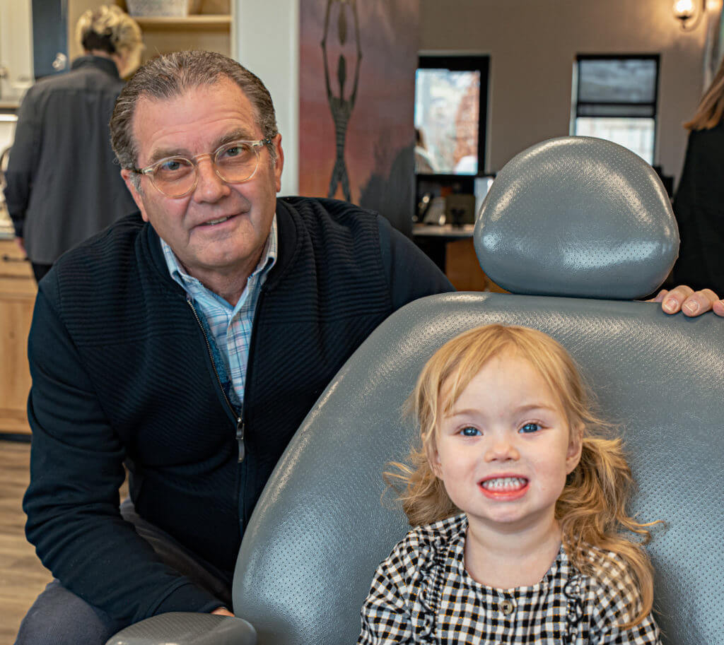 Our pediatric dentist in Centerville, Dr. Mark Nelson, with a smiling, young patient.