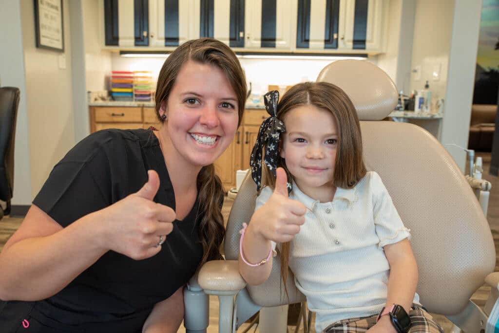 Our Centerville Pediatric Dentistry dental assistant smiling for a picture with a young patient.
